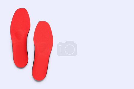 Photo for Red comfortable orthopedic insoles isolated on white background - Royalty Free Image