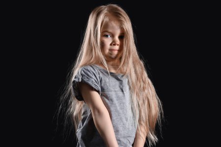 Photo for Homeless little girl against dark background - Royalty Free Image