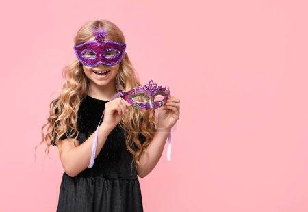 Photo for Funny little girl with carnival masks on pink background - Royalty Free Image