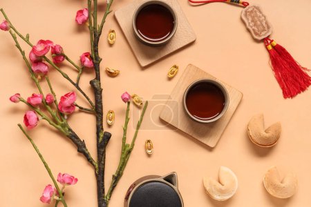 Photo for Sakura with cups of tea, fortune cookies and Chinese symbols on beige background. New Year celebration - Royalty Free Image