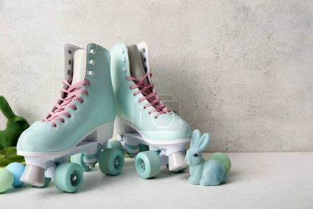 Vintage roller skates with Easter eggs and toys bunny on white background