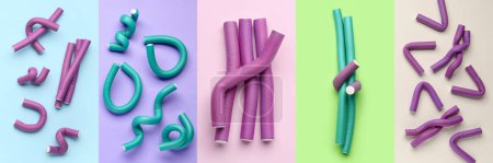 Set of many hair curlers on color background, top view