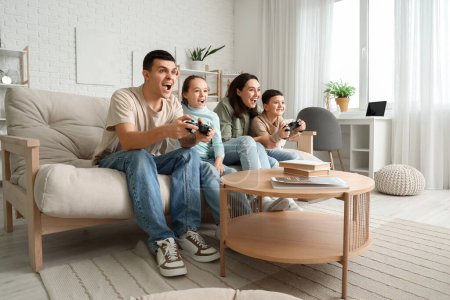 Photo for Happy family playing video game on sofa at home - Royalty Free Image