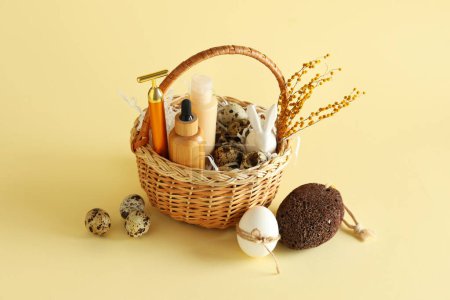 Photo for Basket with spa accessories and Easter decor on color background - Royalty Free Image