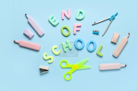 Text END OF SCHOOL, markers and scissors on blue background. Top view