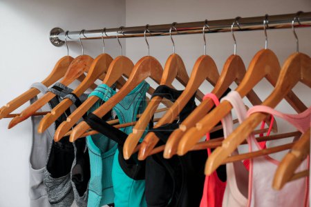 Photo for Rack with stylish sports bras in modern wardrobe - Royalty Free Image