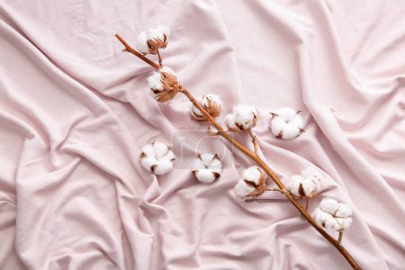 Cotton sprig and flowers on pink bed sheets