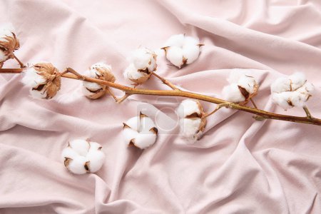 Cotton sprig and flowers on pink bed sheets