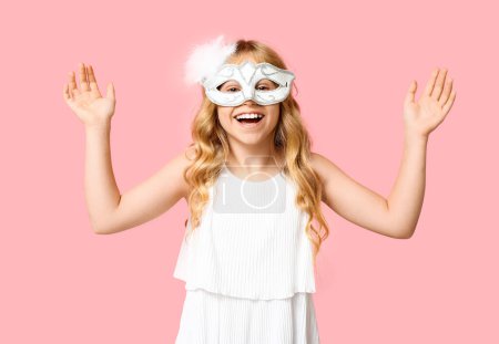Photo for Cute little girl wearing carnival mask on pink background - Royalty Free Image