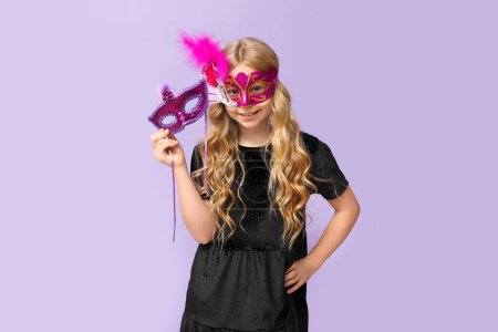Photo for Funny little girl with carnival masks on lilac background - Royalty Free Image