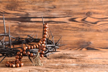 Photo for Crown of thorns and beads with cross on wooden background, closeup. Good Friday concept - Royalty Free Image