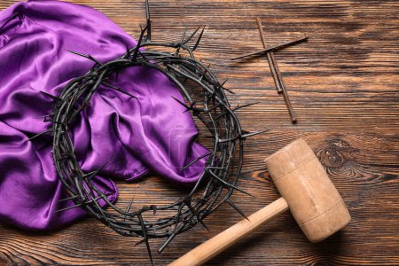 Photo for Crown of thorns with purple cloth, nails and hammer on wooden background. Good Friday concept - Royalty Free Image