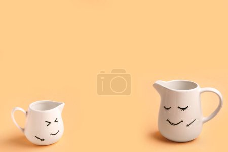 Photo for Pitchers with happy faces for Friendship Day on beige background - Royalty Free Image