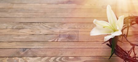 Photo for Crown of thorns and white lily on wooden background with space for text - Royalty Free Image