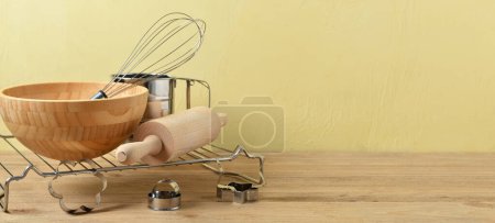 Photo for Baking utensils on table against yellow background with space for text - Royalty Free Image