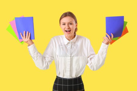 Photo for Female student with copybooks on yellow background. End of school concept - Royalty Free Image