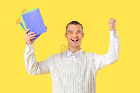 Photo for Male student with copybooks on yellow background. End of school concept - Royalty Free Image