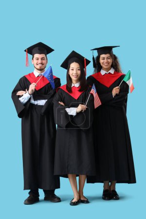 Photo for Graduate students with EU, USA and Ireland flags on blue background - Royalty Free Image