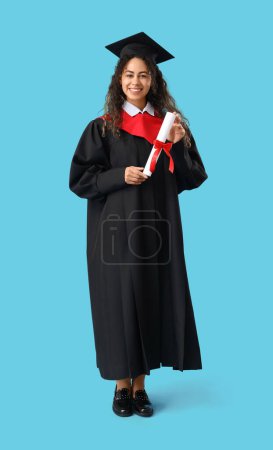 Photo for African-American female graduate student with diploma on blue background - Royalty Free Image