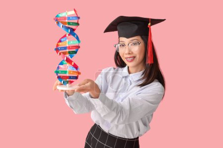 Photo for Asian female graduate student with DNA model on pink background - Royalty Free Image