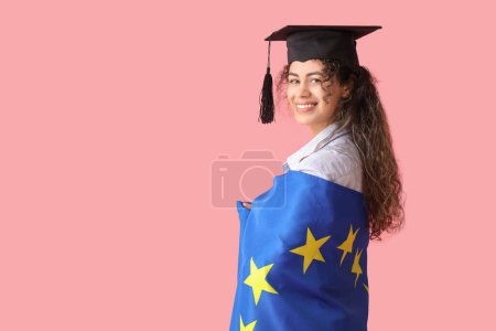 Photo for African-American female graduate student with EU flag on pink background - Royalty Free Image