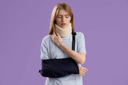 Injured young woman after accident with cervical collar and broken arm on lilac background