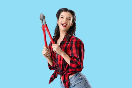 Photo for Beautiful pin-up woman with bolt cutter on color background - Royalty Free Image