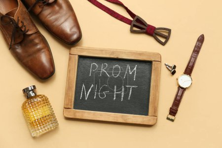 Chalkboard with text PROM NIGHT, male shoes and wristwatch on beige background