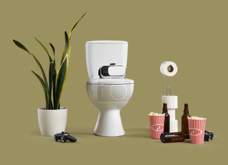 Toilet bowl with VR glasses, game pad, popcorn and beer on green background