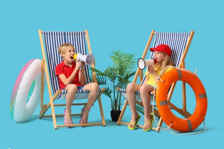 Photo for Little children lifeguards with ring buoy and megaphones sitting on deckchairs against blue background - Royalty Free Image