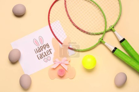 Photo for Composition with greeting card, badminton rackets and Easter decor on beige background - Royalty Free Image