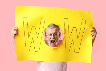 Shocked senior man visible through torn yellow paper with word WOW on pink background