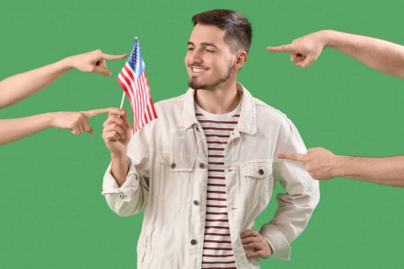 People pointing at young man with USA flag on green background. Accusation concept