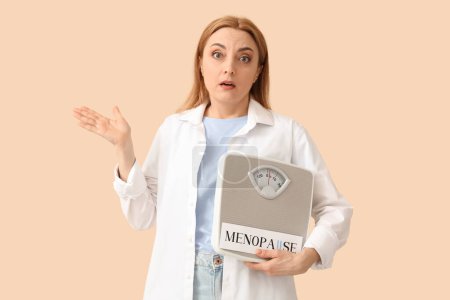 Mature woman holding paper with word MENOPAUSE and weight scales on beige background