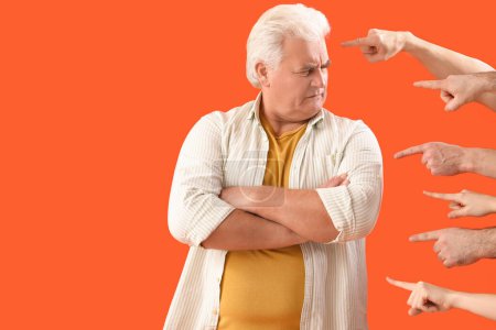 Photo for People pointing at mature man on orange background. Accusation concept - Royalty Free Image