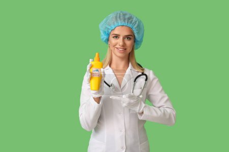 Female doctor with mosquito repellent on green background