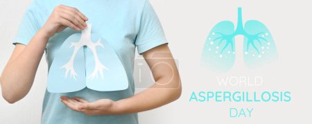 Woman with paper lungs on light background. Banner for World Aspergillosis Day