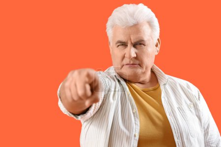 Photo for Mature man pointing at viewer on orange background, closeup. Accusation concept - Royalty Free Image
