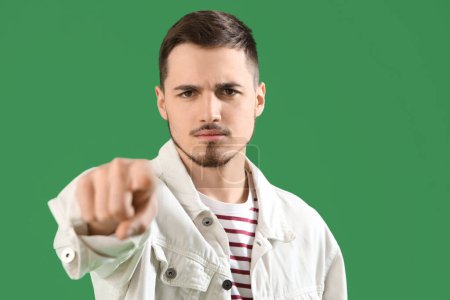 Photo for Young man pointing at viewer on green background, closeup. Accusation concept - Royalty Free Image