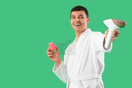 Photo for Young man with different epilators on green background - Royalty Free Image
