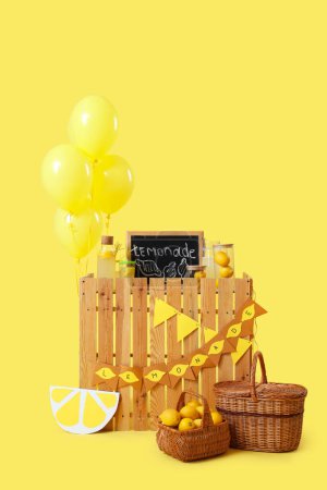 Lemonade stand with chalkboard and balloons on yellow background