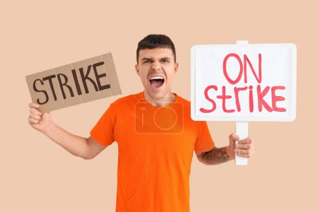Photo for Protesting young man with placards on beige background. Strike concept - Royalty Free Image