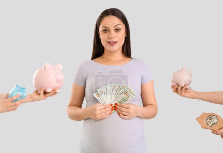 Young pregnant woman with money and piggy banks on light background. Maternity Benefit concept