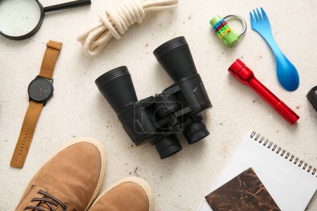 Photo for Binoculars, wristwatch, torch and lock on light background - Royalty Free Image