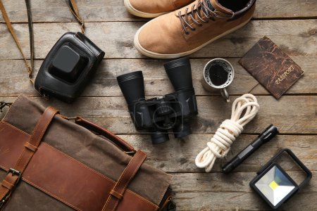 Photo for Binoculars, cup of coffee, passport and travel items on wooden background - Royalty Free Image