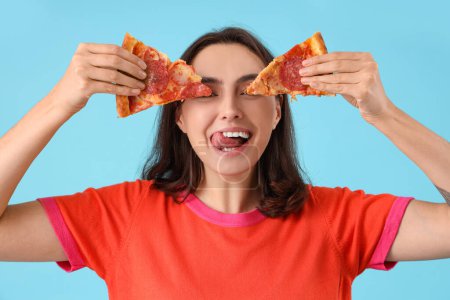 Photo for Young woman with tasty pepperoni pizza on blue background, closeup - Royalty Free Image