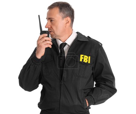 Mature FBI agent with two-way radio on white background