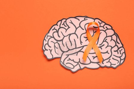 Paper brain and orange ribbon on color background. Multiple Sclerosis Awareness Month