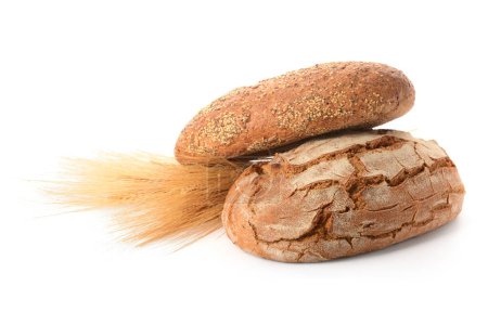 Photo for Loaves of fresh bread with wheat spikelets on white background - Royalty Free Image