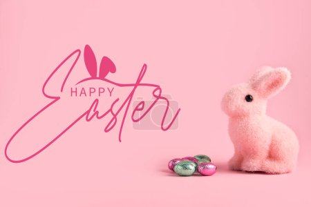 Photo for Beautiful Easter greeting card with chocolate eggs and toy rabbit on pink background - Royalty Free Image